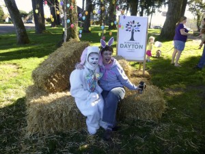Easter Bunny sitting on hay bales with volunteer